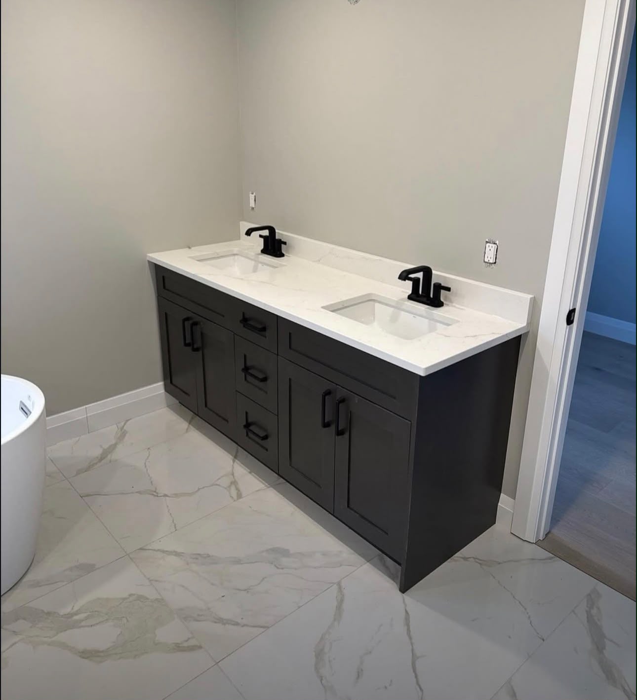 Custom double vanity installation with matte black fixtures in a Richmond Hill home